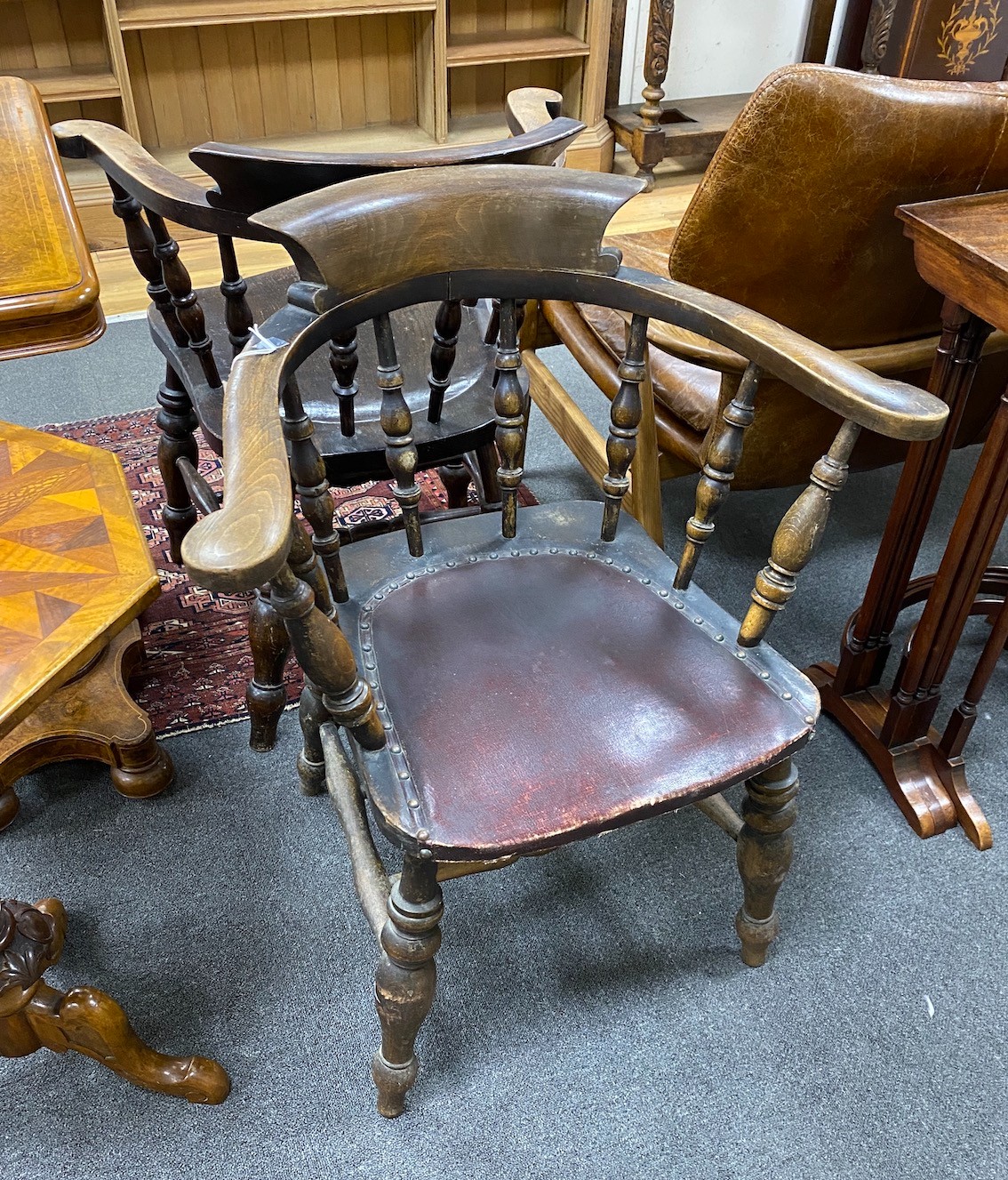 A pair of late Victorian beech and elm smoker's bow elbow chairs, width 67cm, depth 51cm, height 84cm